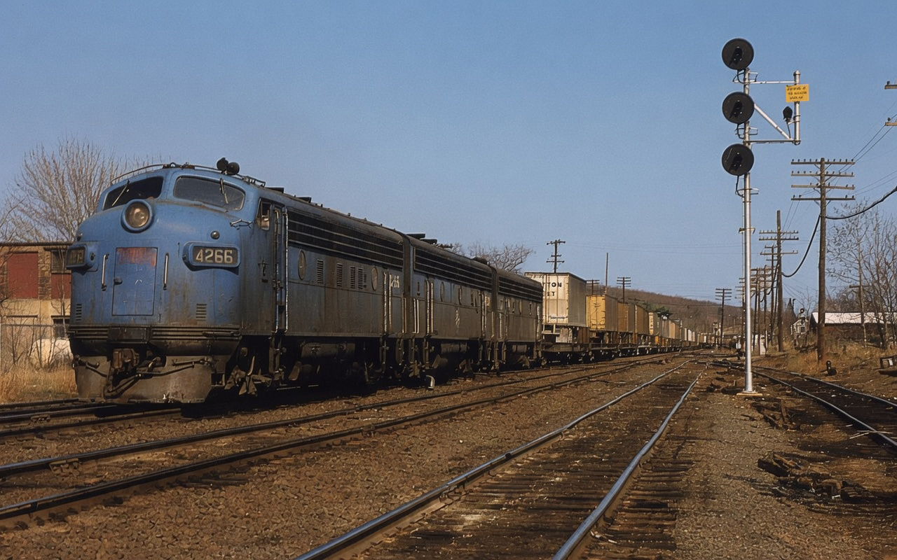Boston and Maine F7s led by 4266 with a piggyback freight at Ayer Massachusetts circa 1970