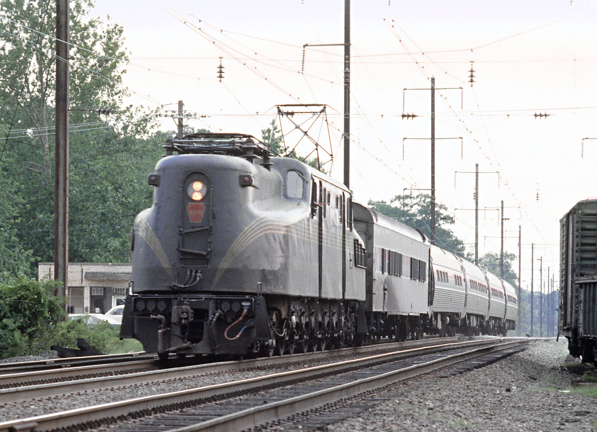 Amtrak GG1 4935 in Brunswick green and gold pinstripes with Metroliner 121 at Seabrook, Maryland, June 29, 1978