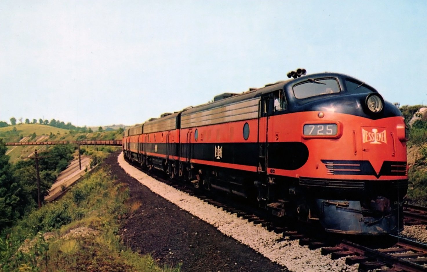 Bessemer and Lake Erie F7 725 leading a string of hoppers on the main line in Pennsylvania circa 1955