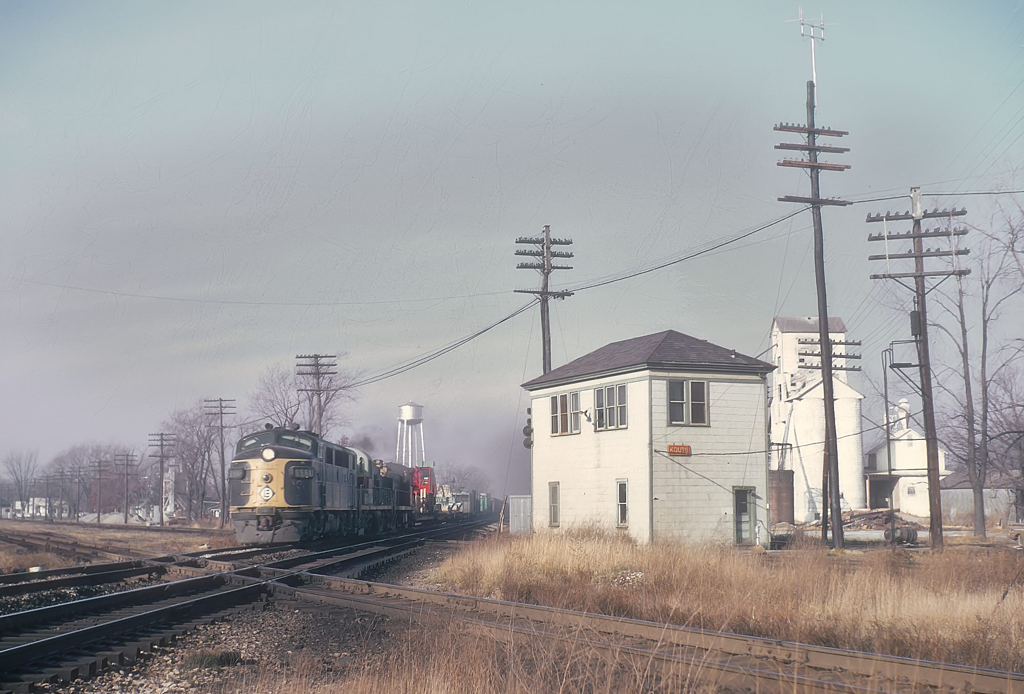 Erie Lackawanna F3A 6561 eastbound freight through PRR interlocking at Kouts Indiana November 1966