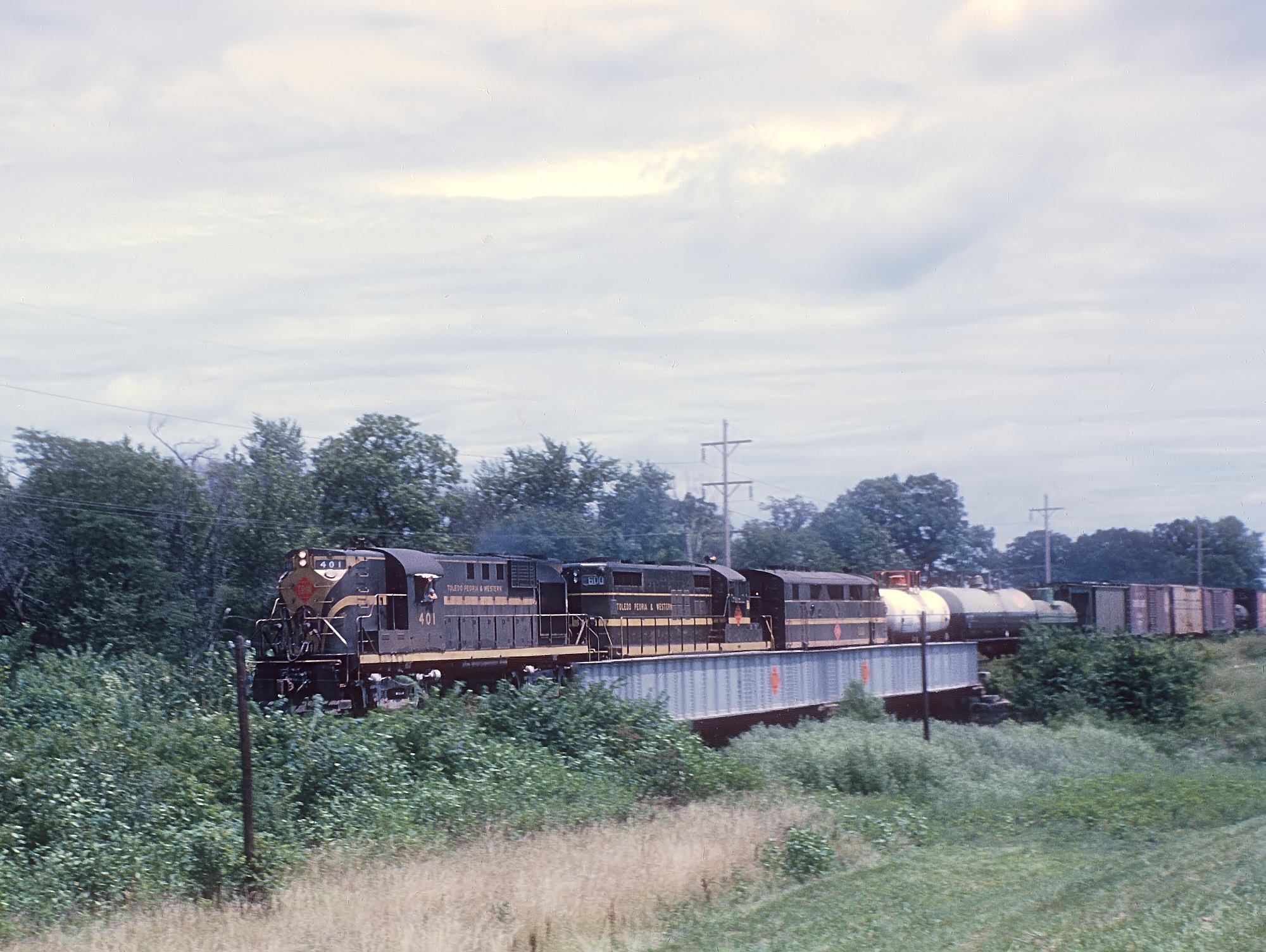 Toledo, Peoria and Western RS11 401, GP18 600, and F3A 100A near Leonard, Illinois, in July 1962