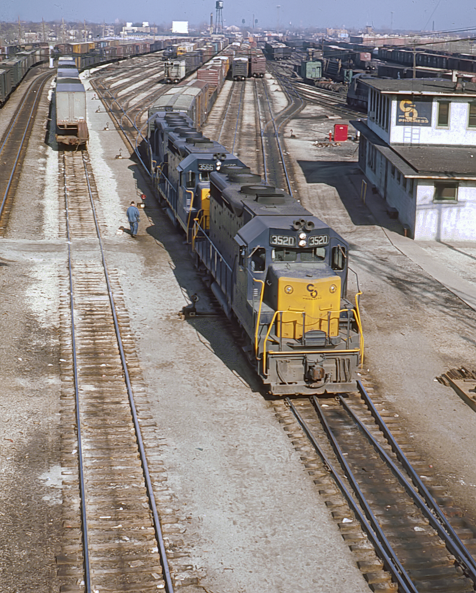 Trio of Chesapeake and Ohio GP35s led by 3520 and 3566 leaving Rockwell Yard at Kedzie Avenue and 75th Street Chicago April 9 1965