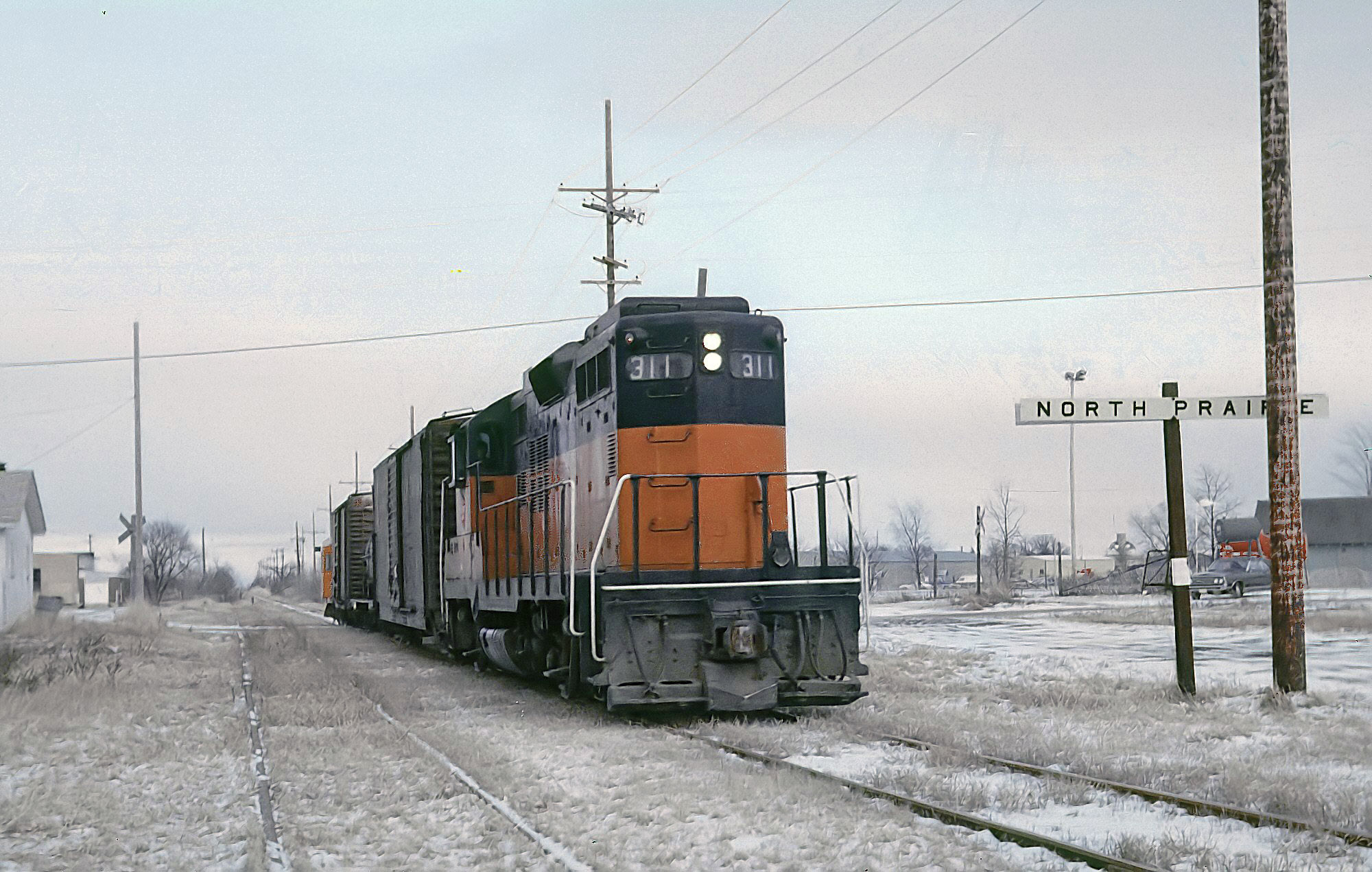 Milwaukee Road GP9 311 with a short train at North Prairie, Wisconsin, on January 17, 1975