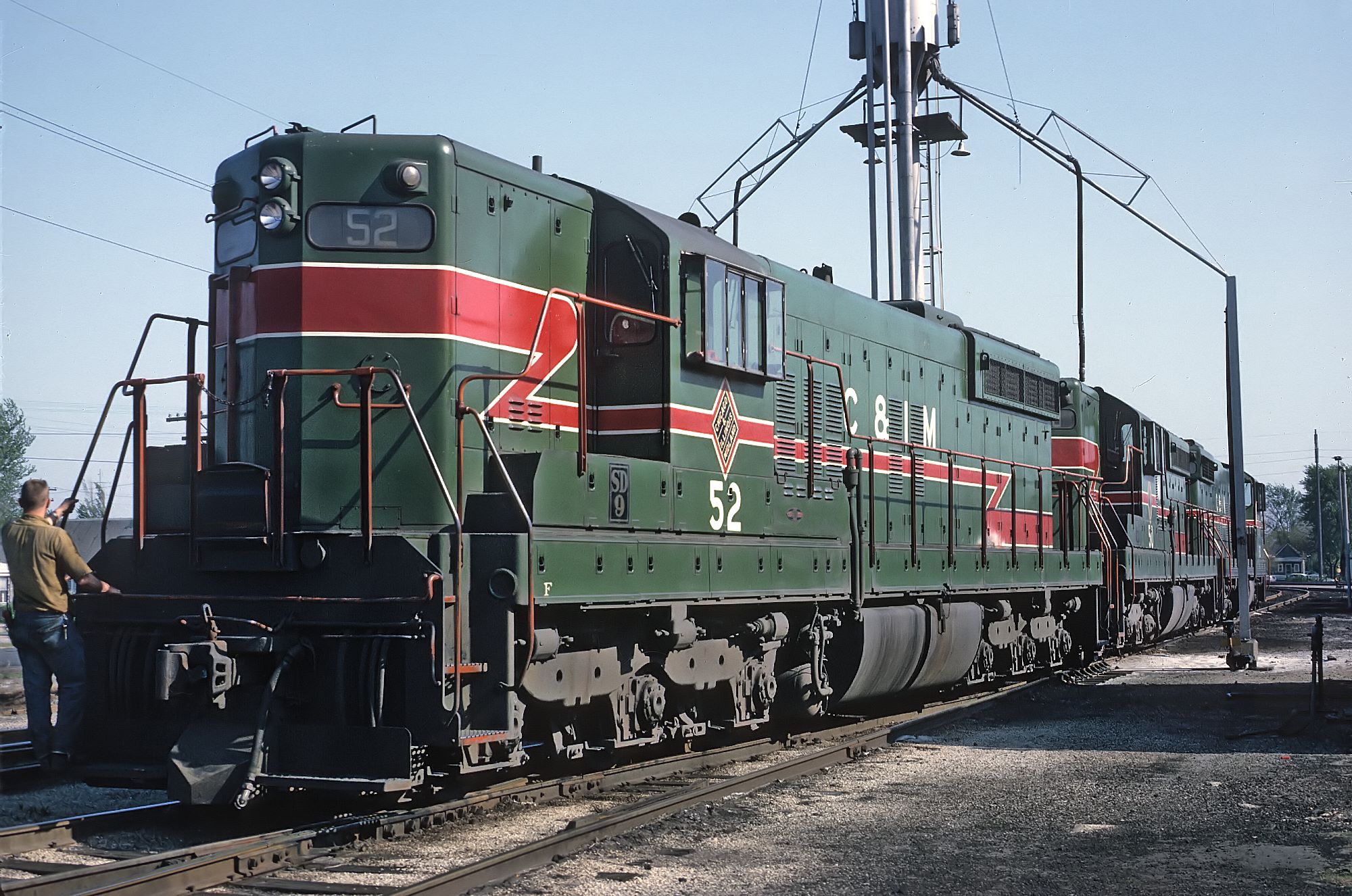A crewman on the footboard of Chicago and Illinois Midland SD9 52 at Springfield on May 7, 1966