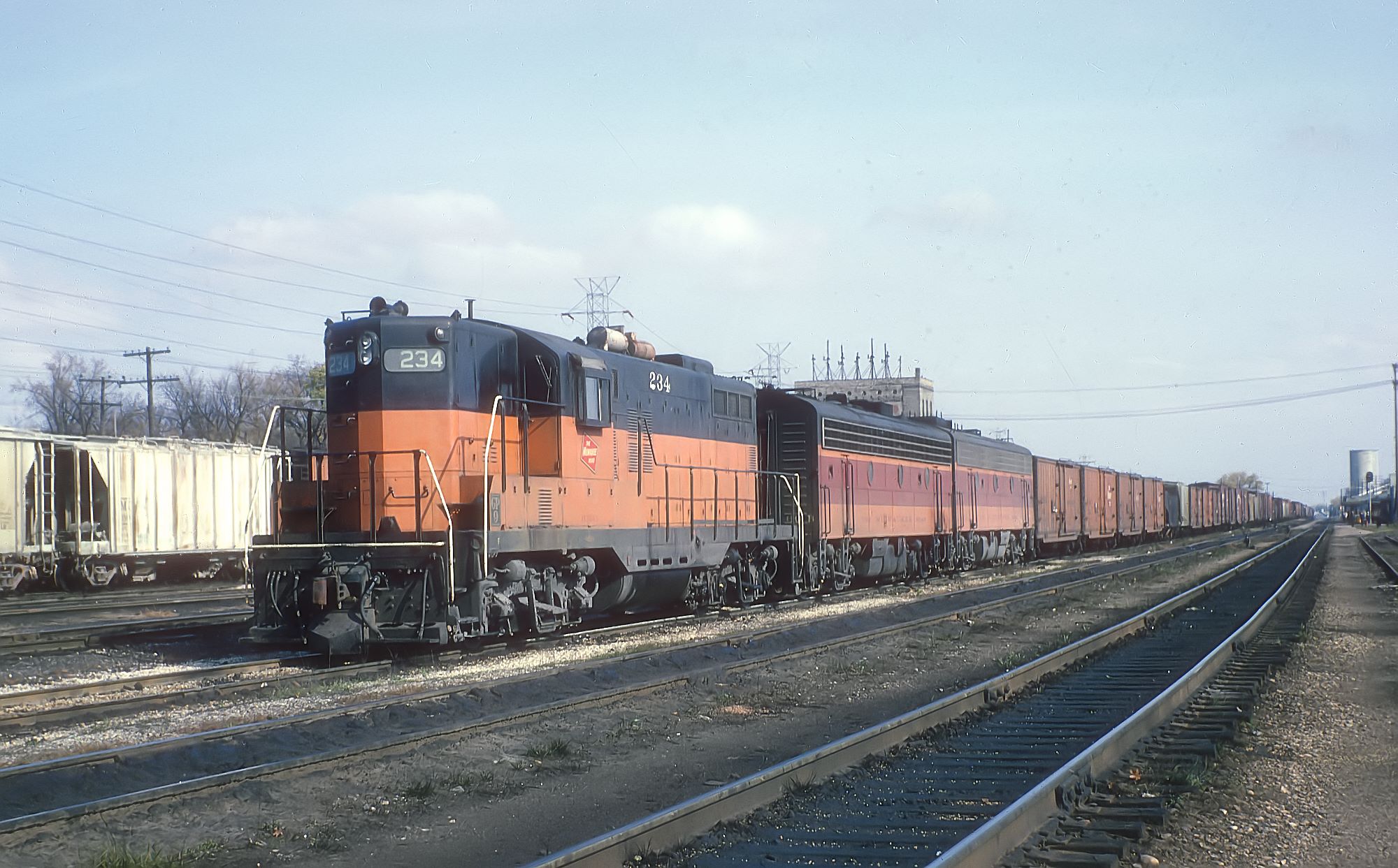 Milwaukee Road GP9 234 and a pair of B units in freight service at Portage, Wisconsin, in November 1965