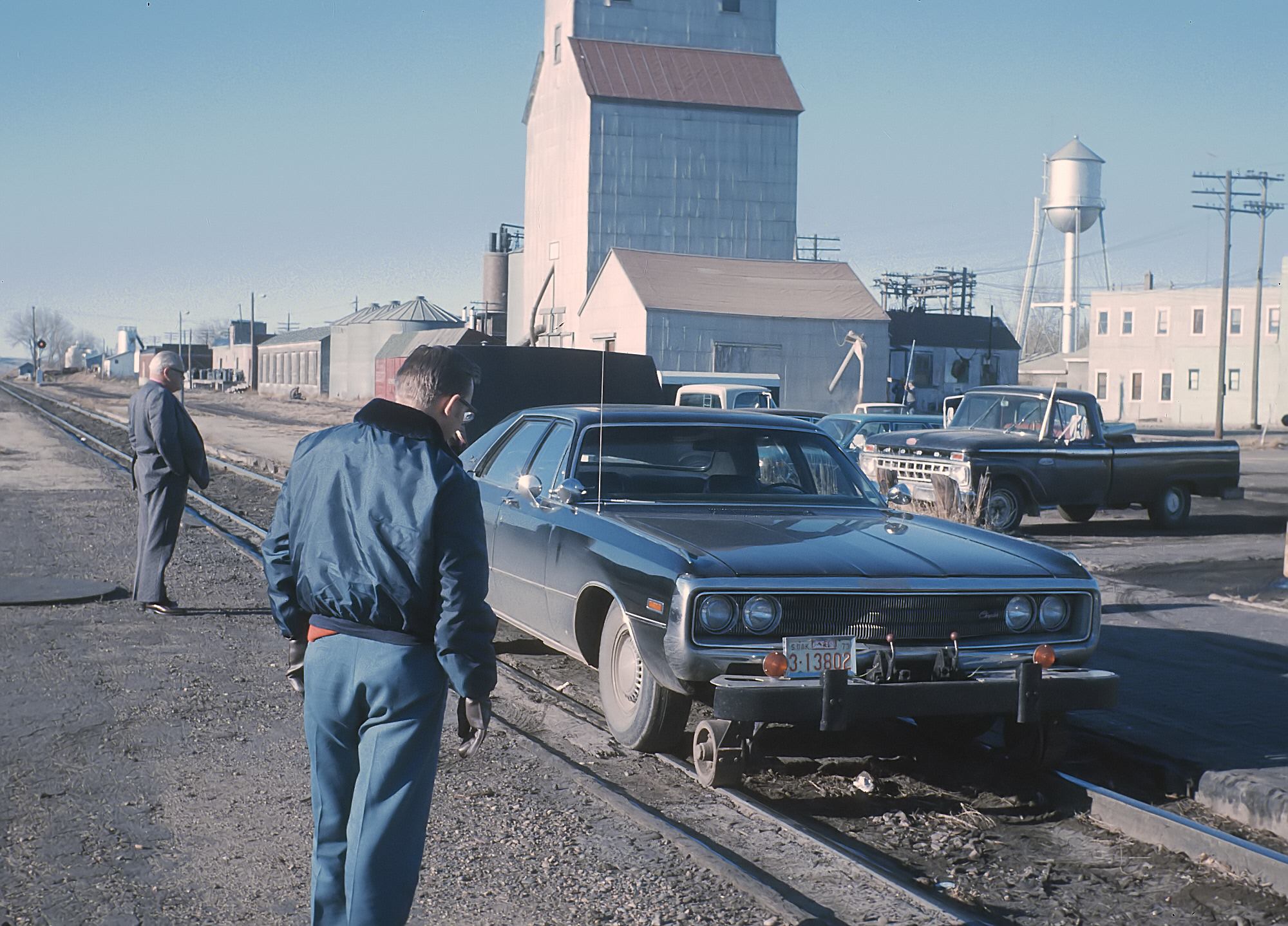 A Milwaukee Road 1970 Chrysler Newport hy-rail at La Crescent, Minnesota, in March 1974