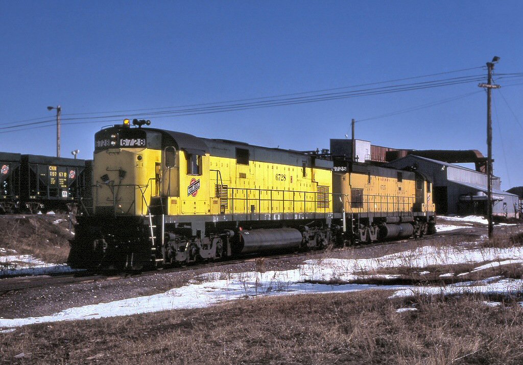 Chicago and North Western C628s 6728 and 6725 at the ore dumper in Escanaba, April 1985