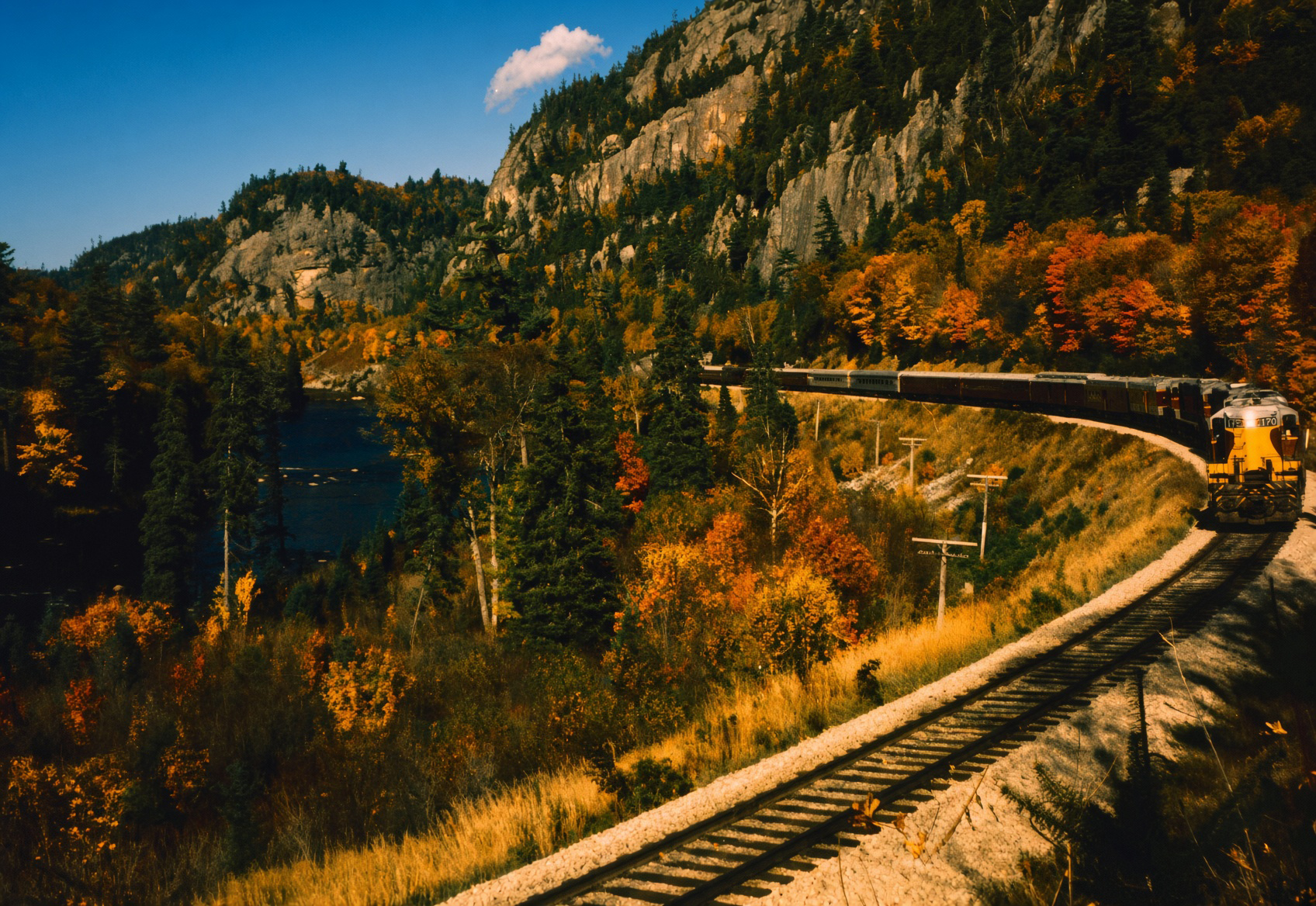 Algoma Central GP7s led by No. 170 on the Agawa Canyon Train along the Agawa River in the 1960s