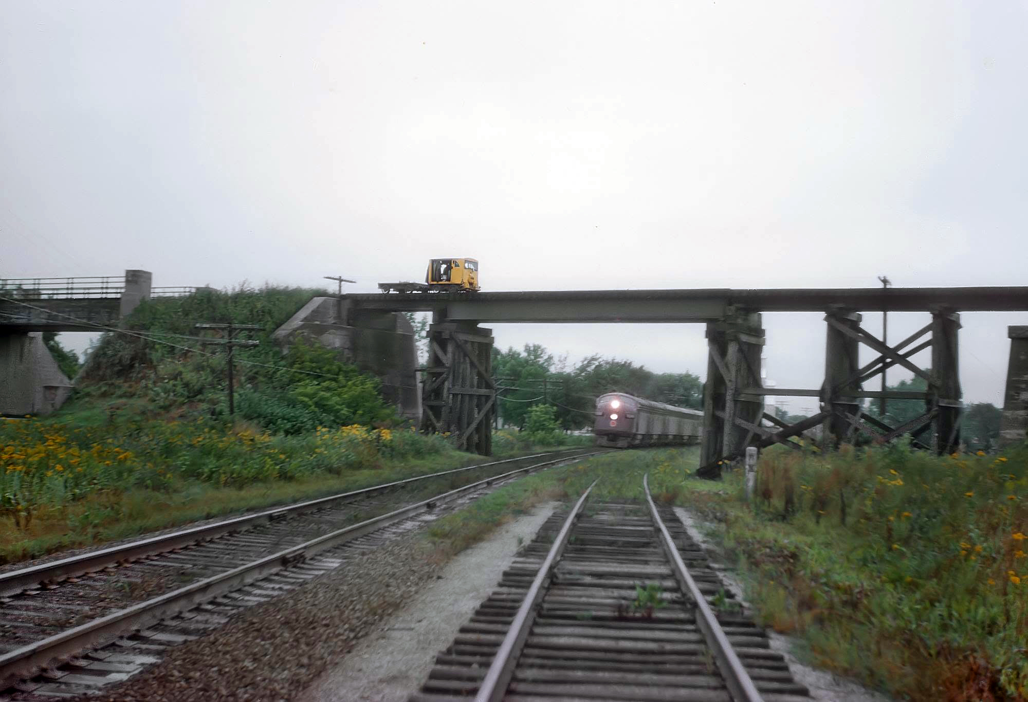 Chicago Great Western F3A 115A ducking under Milwaukee Road overpass Kenyon Minnesota September 1962