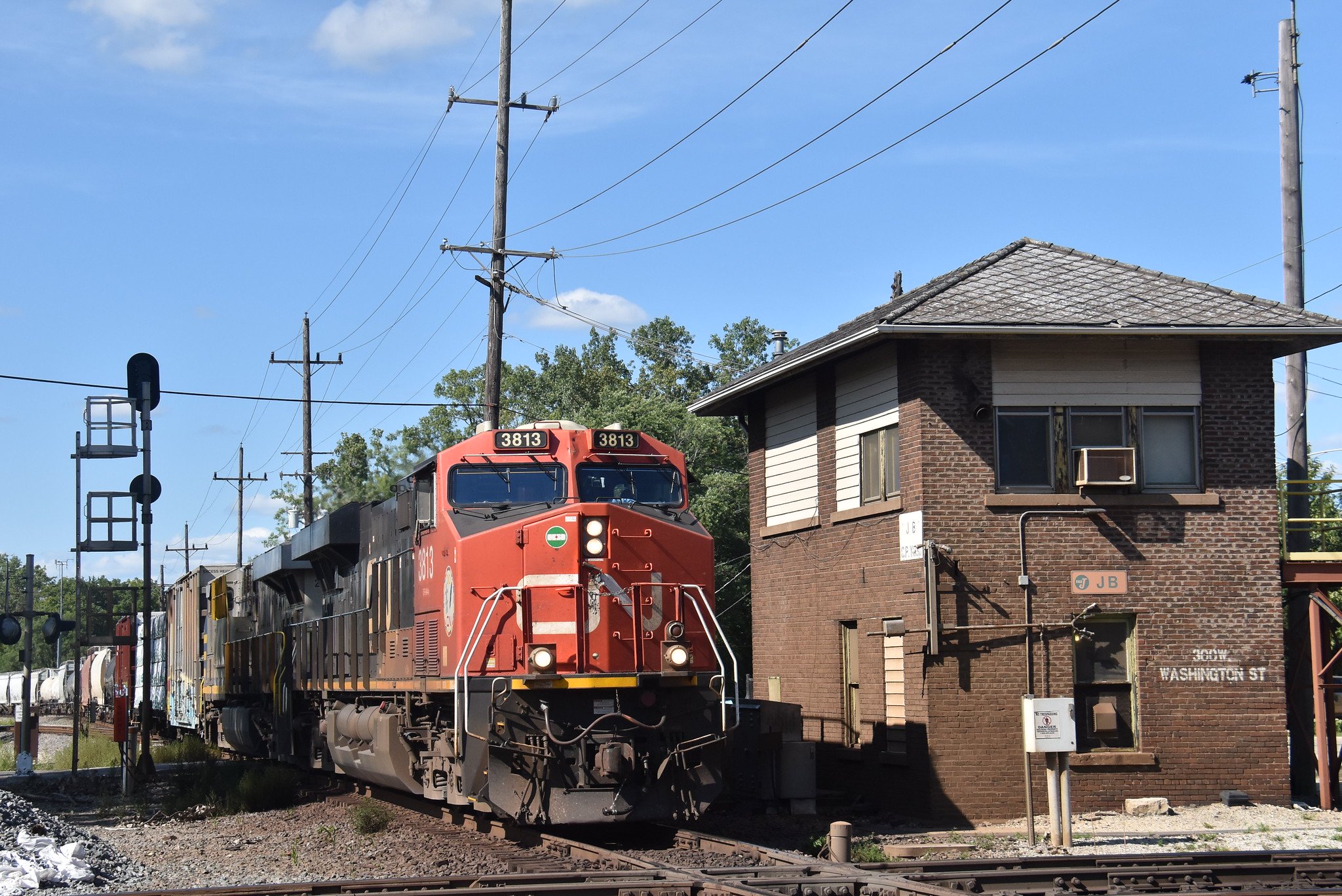 Canadian National ES44AC 3813 at manned JB Tower about to cross the Union Pacific diamond in West Chicago Illinois August 11 2024