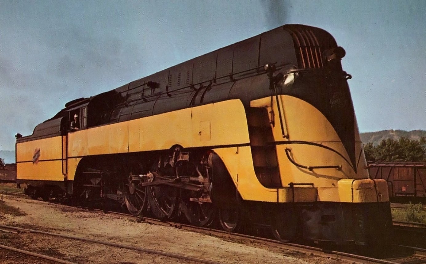 Chicago and North Western streamlined Class E 4-6-2 1617 posed in yellow and green for the Minnesota 400 late 1940s publicity photograph