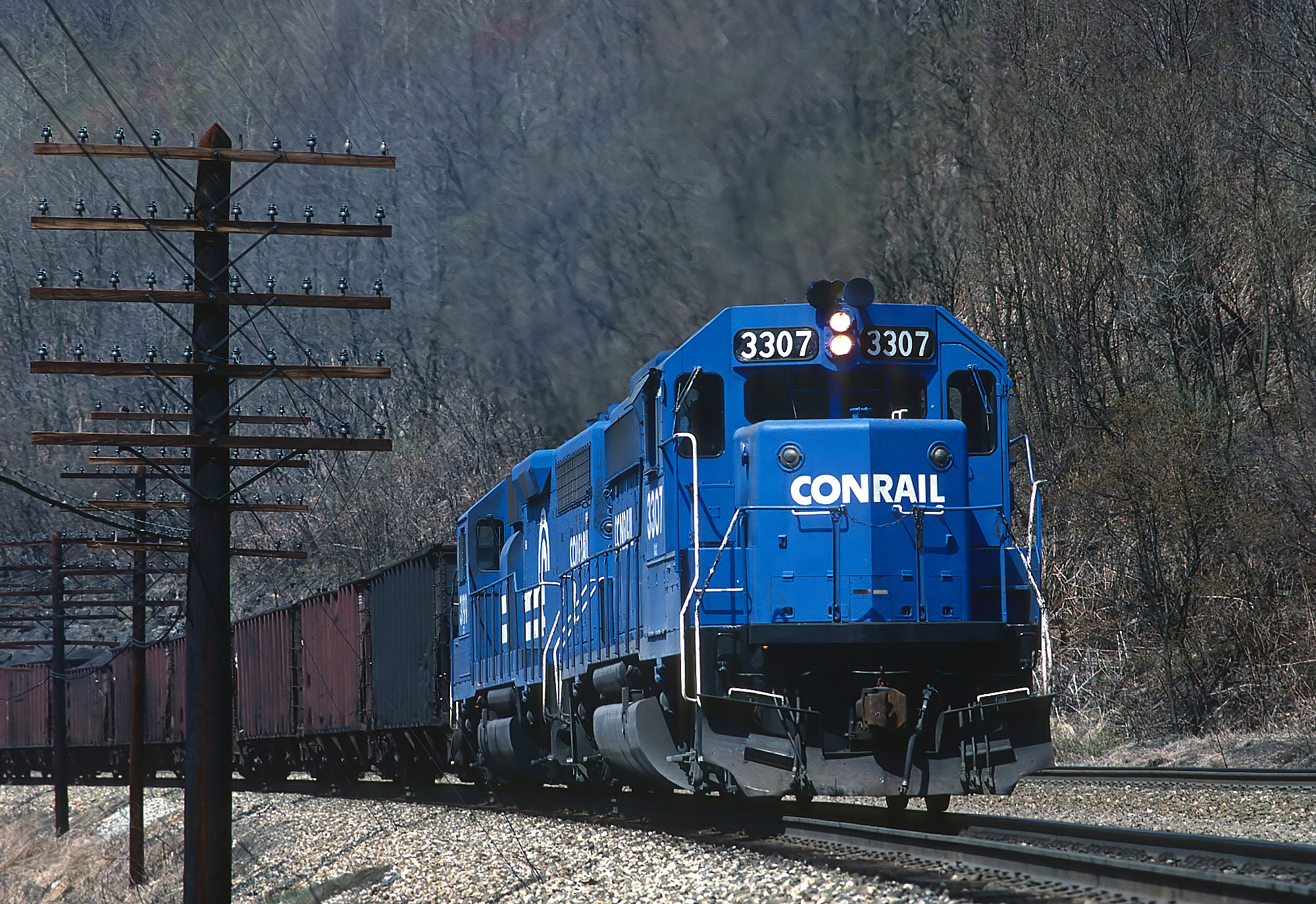 Conrail GP40-2s led by 3307 with loaded coal at South Fork Pennsylvania April 22 1988