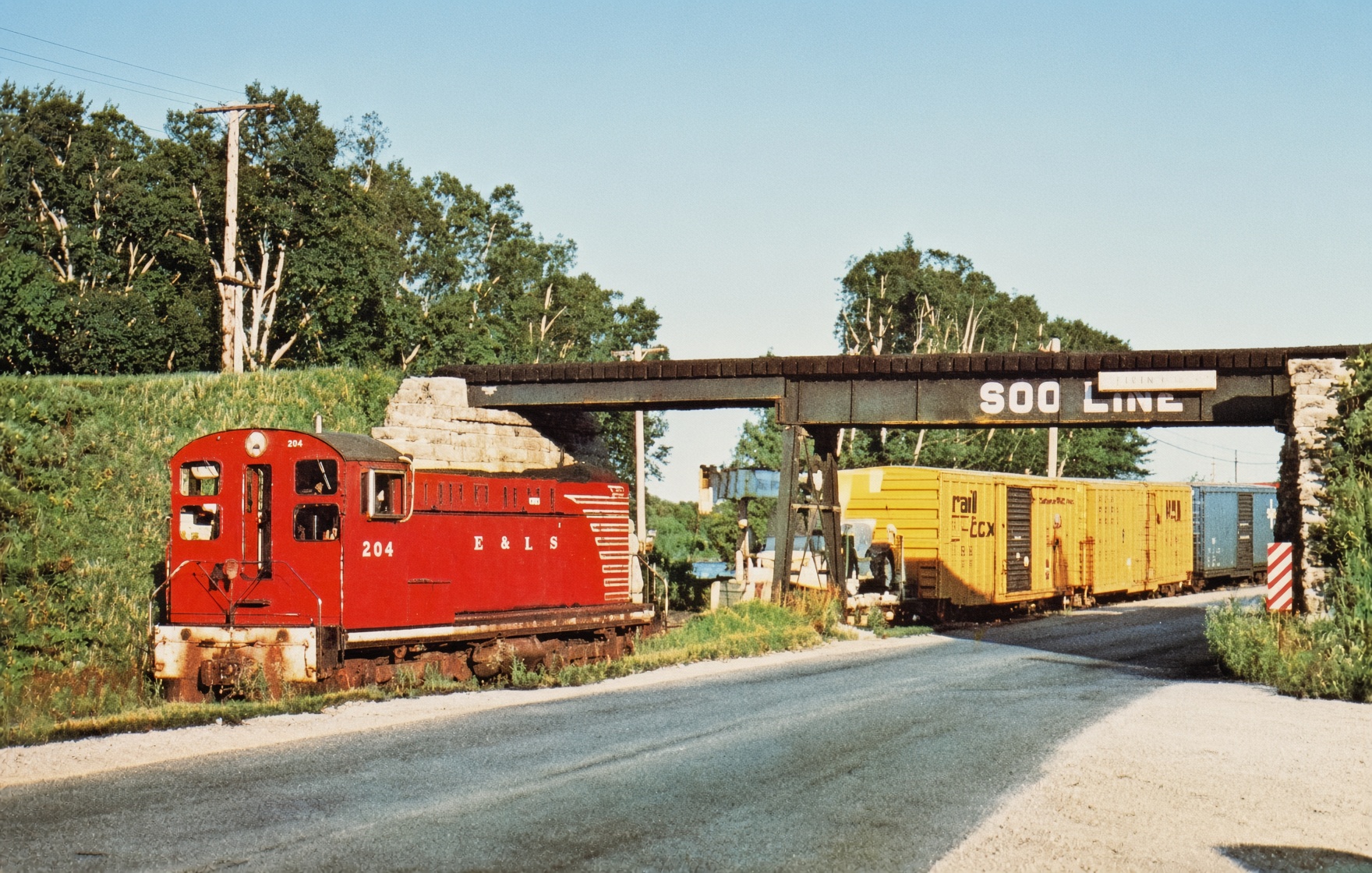 Postcard of Escanaba and Lake Superior DS-4-4-1000 No. 204 westbound under the Soo Line at Wells