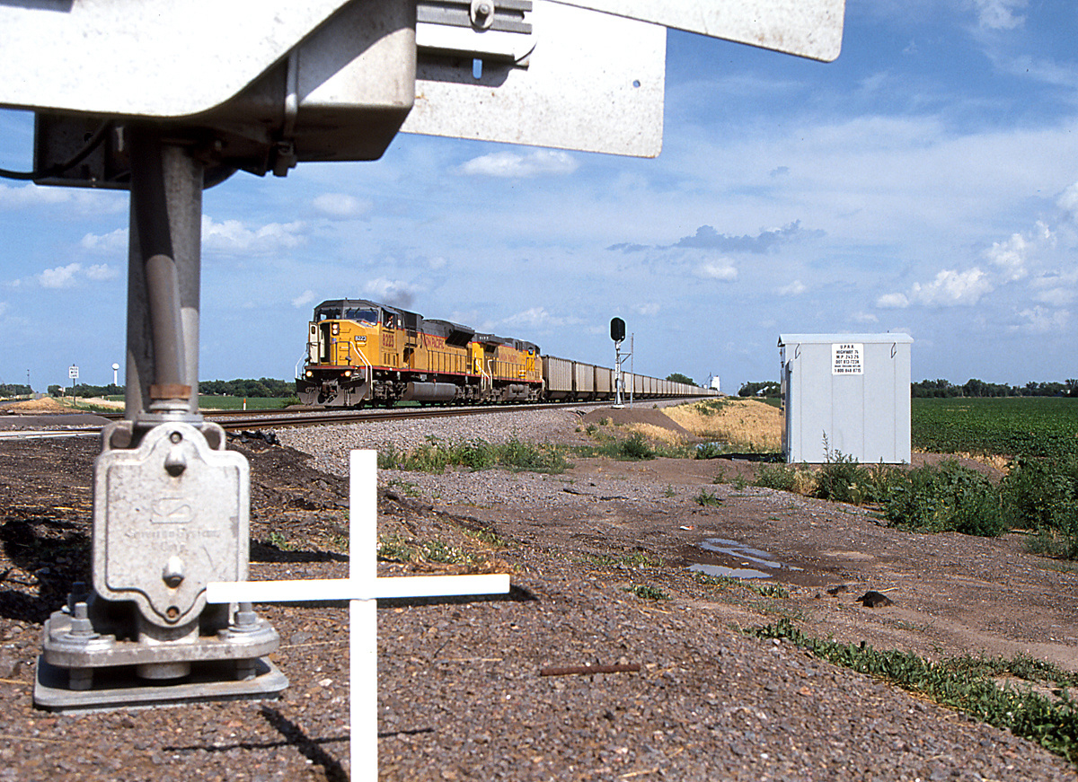 Union Pacific SD90MAC 8223 passing a small memorial near Fairfield Nebraska June 23 2000