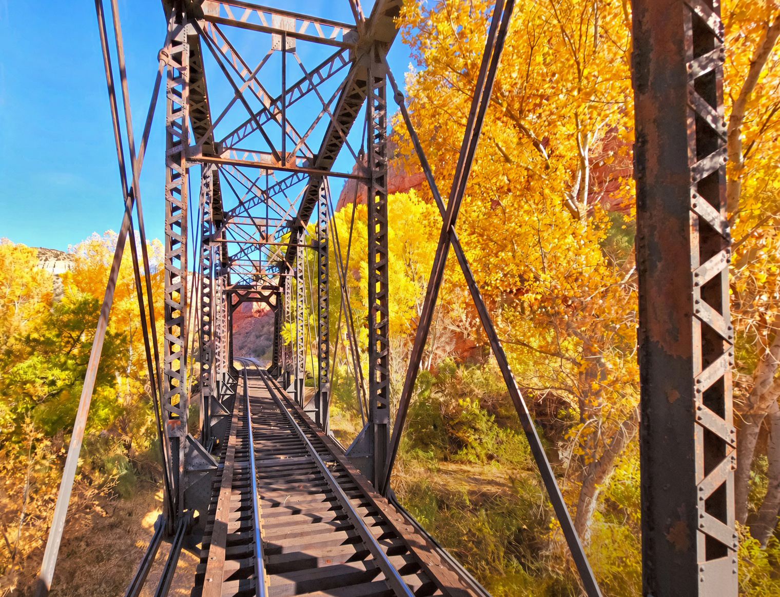 Verde Canyon Railroad train through cottonwood fall colors and red rock