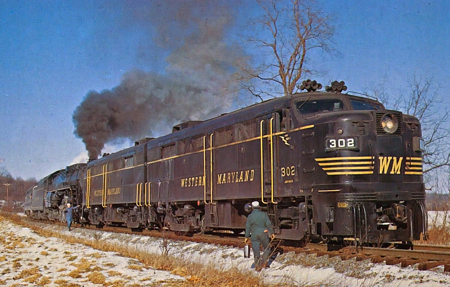 Western Maryland FA-2 302 leads a Steam Tours excursion with Reading 4-8-4 2102 at Orrtanna Pennsylvania on February 5 1972